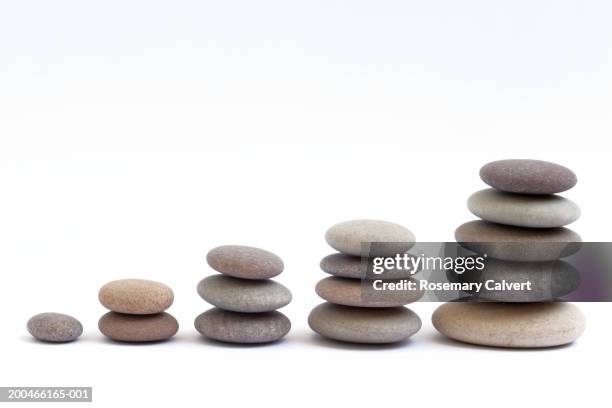 five stacks of round, smooth pebbles - pebble stock pictures, royalty-free photos & images