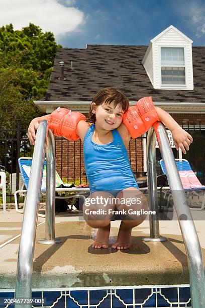 Pool Crounching 143 Girl On Ladder At Swimming Pool Stock Photos, High-Res Pictures ...