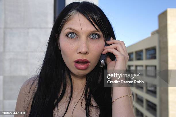 young woman using mobile phone, portrait, close-up - staring stock pictures, royalty-free photos & images
