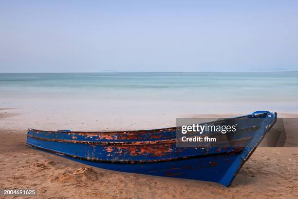 old rowboat on the beach - solitaire stock pictures, royalty-free photos & images