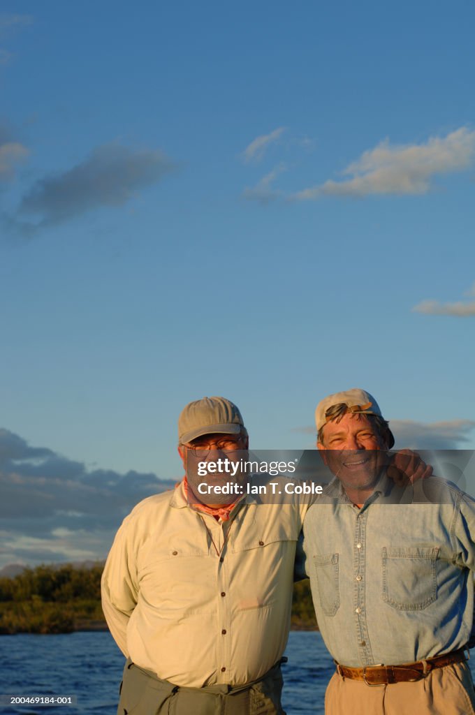 USA, Alaska, two mature men beside Goodnews River, smiling, portrait