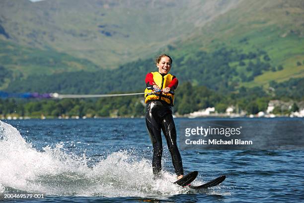 girl (13-15) waterskiing on lake, smiling - lake windermere bildbanksfoton och bilder