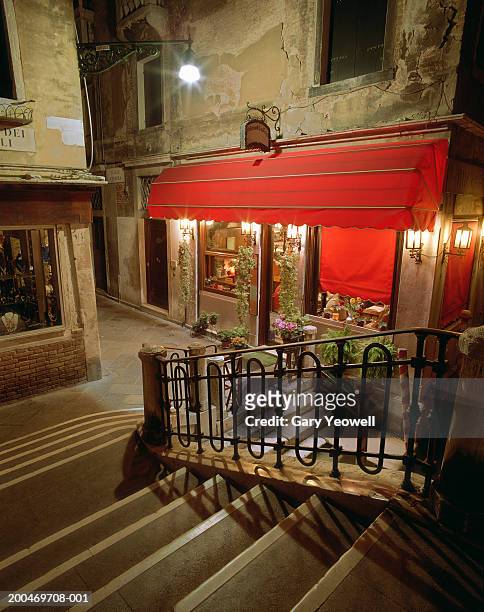 italy, venice, restaurant in narrow street at night - awning window fotografías e imágenes de stock