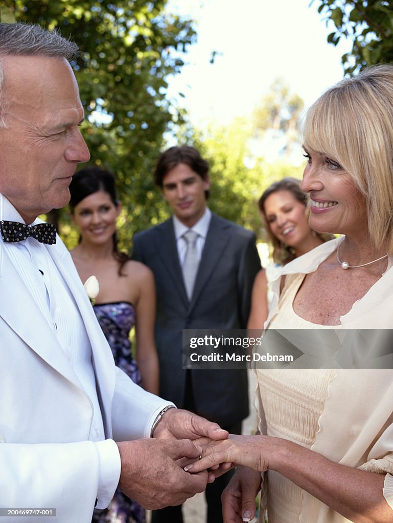 Bride and groom holding hands at wedding