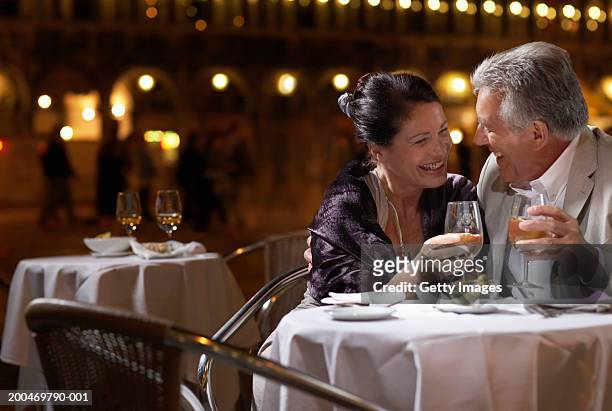 italy, venice, couple at restaurant table at night, outdoors - elegant couple stock pictures, royalty-free photos & images