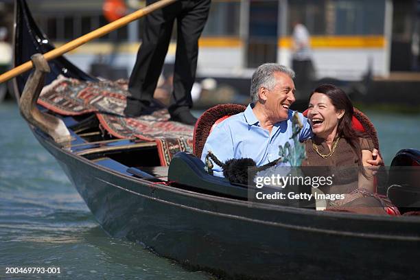 italy, venice, couple riding in godola, laughing - venedig gondel stock-fotos und bilder