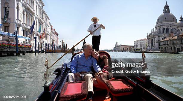 "italy, venice, couple riding in godola, woman leaning against man" - canal stock-fotos und bilder