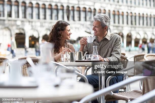 italy, venice, couple at cafe table, outdoors, smiling at each other - venice with couple stock pictures, royalty-free photos & images