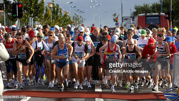 iceland, reykjavik marathon, participants at start of race - large group of people running stock pictures, royalty-free photos & images
