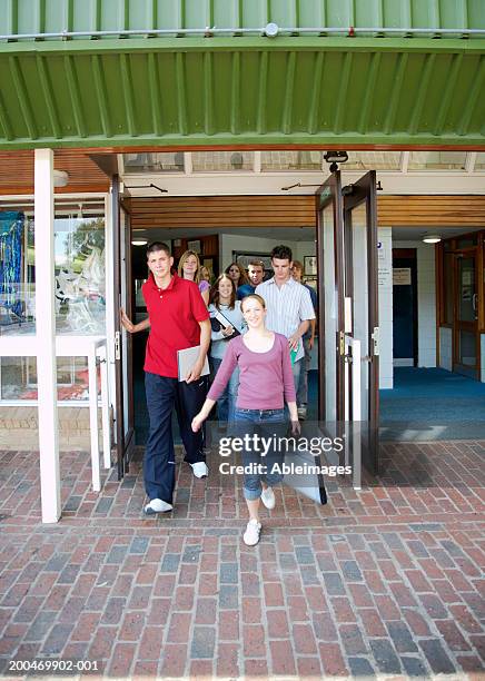 "sixth form students leaving college building, smiling" - high school building entrance stock pictures, royalty-free photos & images