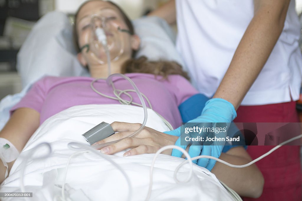 Paramedic tending to female patient in ambulance, close-up