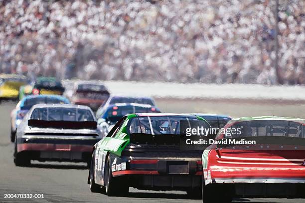 stock car race, rear view - nascar stock pictures, royalty-free photos & images