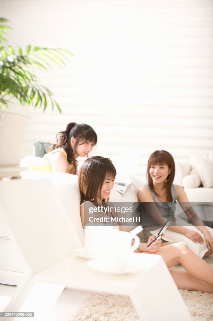 Three young women talking and laughing, side view