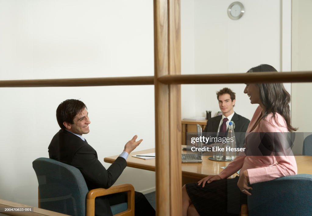 People smiling in business meeting