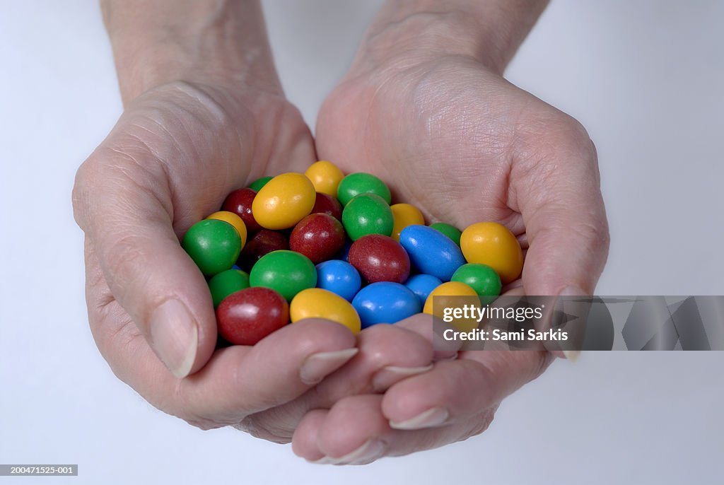 Woman holding coloured chocolate eggs, close-up