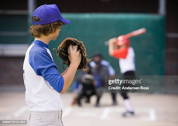 pitcher (13-15) preparing to throw baseball to batter - young baseball pitcher stock pictures, royalty-free photos & images