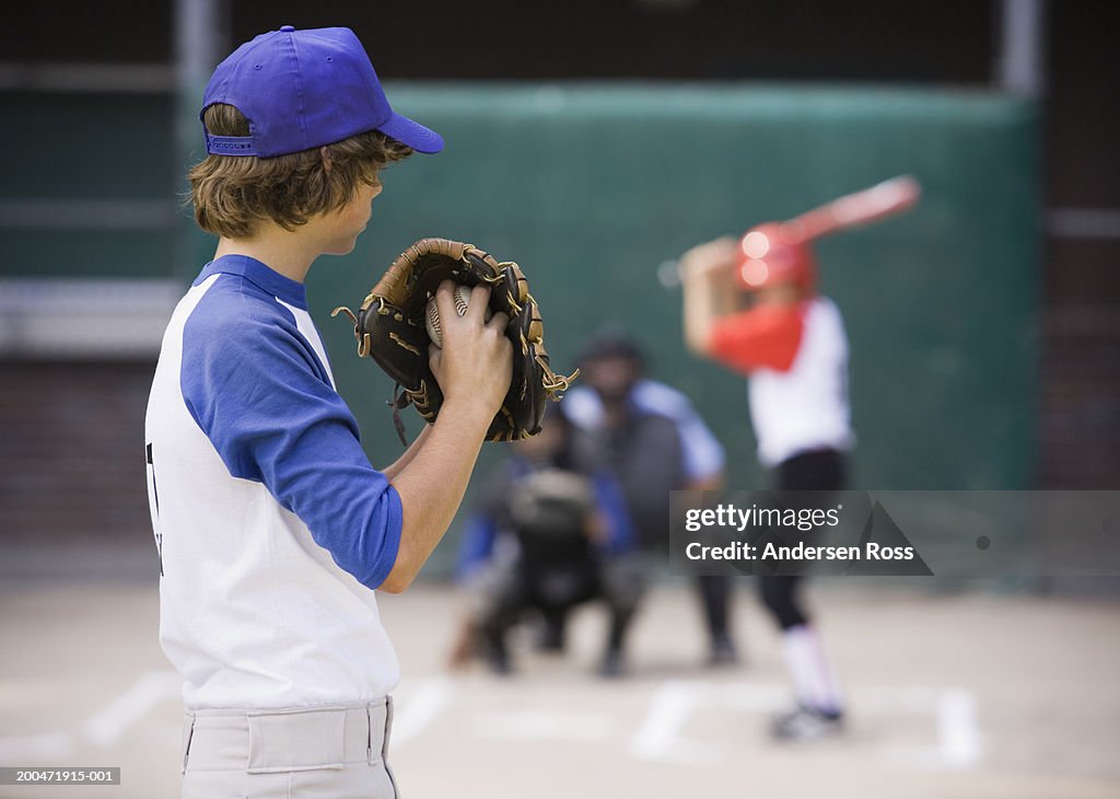 Pitcher (13-15) preparing to throw baseball to batter