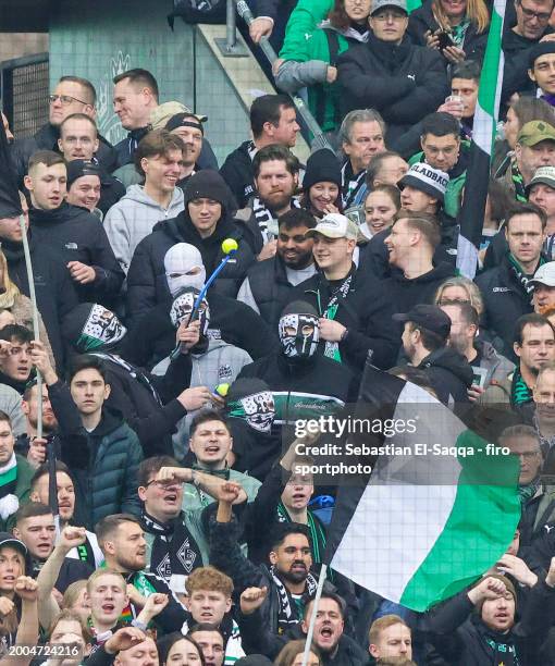 Fans of Borussia Mönchengladbach use ball slingers to spin tennis balls onto the field during the Bundesliga match between Borussia Mönchengladbach...