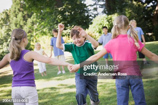 Red Raver Group Of Children Playing Red Rover In Yard High-Res Stock Photo ...