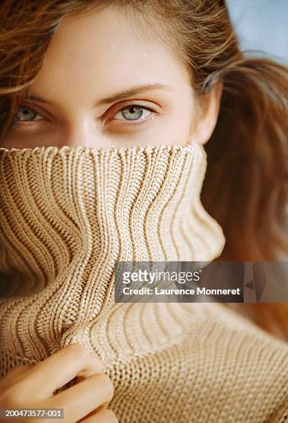 young woman with turtleneck over face, smiling, close-up, portrait - turtleneck stock pictures, royalty-free photos & images
