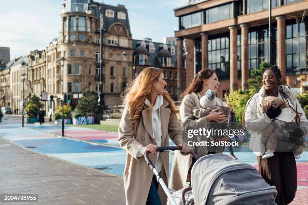 mums and prams discovering the city - carriage stock pictures, royalty-free photos & images