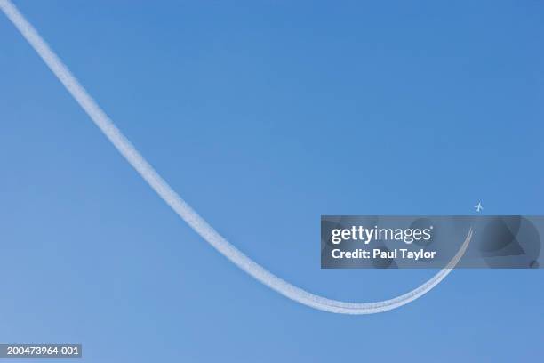 jet vapour trail in sky (digital enhancement) - slipstream stock pictures, royalty-free photos & images