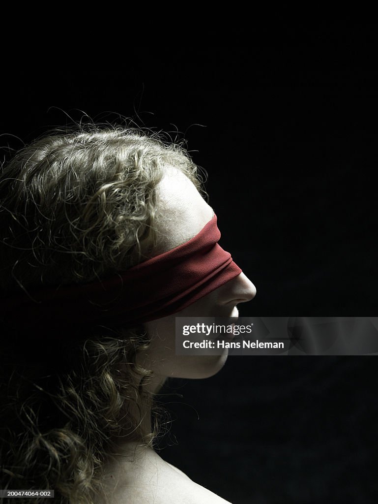 Serious Woman Adjusts Blindfold Over Her Eyes Stock Photo, Picture and  Royalty Free Image. Image 70769576.