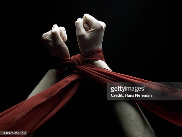 young woman raising tied hands upwards, rear view - s & m stock pictures, royalty-free photos & images