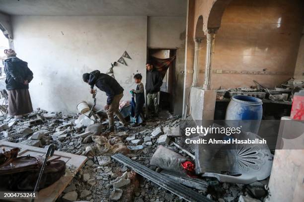 People inspect the damage to their homes following Israeli air strikes on February 12, 2024 in Rafah, Gaza. Strikes intensified overnight as Israel...