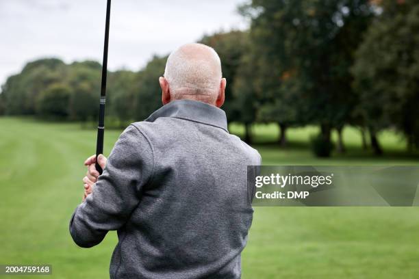 golf, swing and old man at sports club for game, leisure and playing on weekend hobby in retirement. hit, course and senior person on green lawn for competition, outdoor challenge and golfer on field - strike back stock pictures, royalty-free photos & images