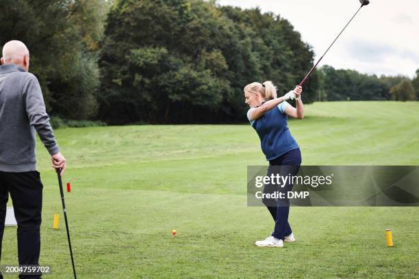 woman, golf course and swing club on field for training, contest or sport in summer with fitness. girl, athlete and people with outdoor games for workout, wellness and exercise on grass in scotland - championship day two stock pictures, royalty-free photos & images