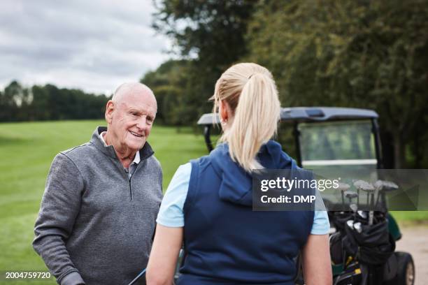 old man, woman and golf course or coach for training on field at country club for competition, practice or behind. people, equipment kit and recreation hobby on exercise lawn, discussion or playing - championship day two stock pictures, royalty-free photos & images