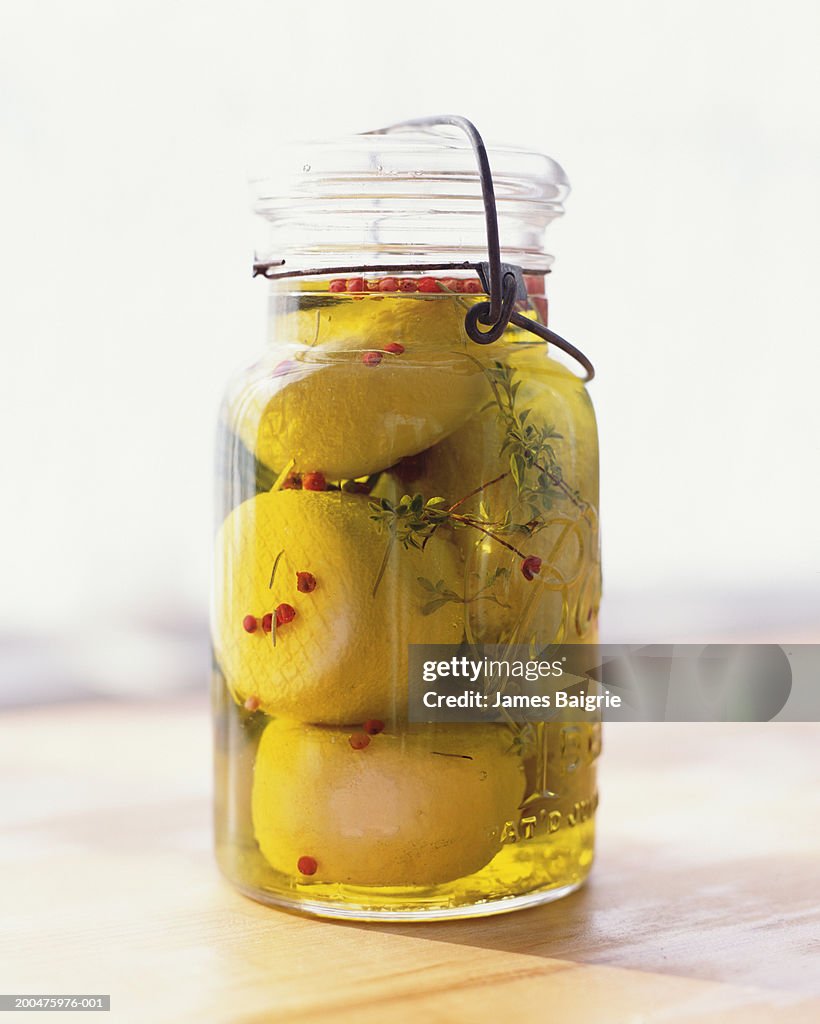 Goat cheese in jar of olive oil with thyme