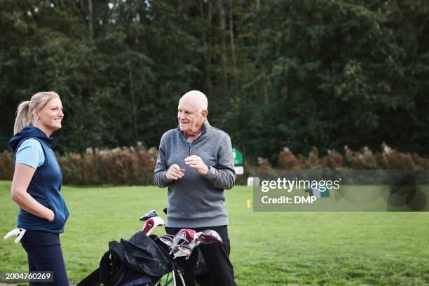 old man, coach and golf course for training sports at country club for competition, practice or together. people, equipment kit and recreation hobby on exercise lawn or discussion, play or teamwork - active seniors golf stock pictures, royalty-free photos & images