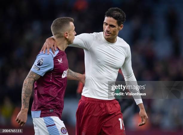 Lucas Digne of Aston Villa interacts with Raphael Varane of Manchester United after the Premier League match between Aston Villa and Manchester...