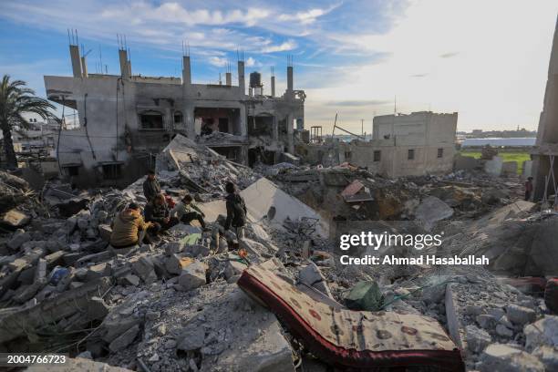 People inspect the damage to their homes following Israeli air strikes on February 12, 2024 in Rafah, Gaza. Strikes intensified overnight as Israel...