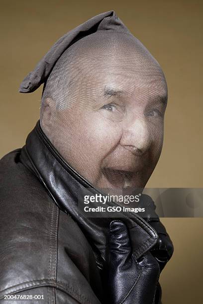 mature man wearing stocking on head, shouting, portrait - bankräuber stock-fotos und bilder