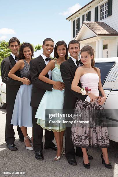 teenage couple (15-18) and young couples in evening dress, smiling - prom limousine stock pictures, royalty-free photos & images