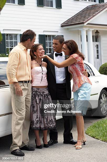 young couple in evening dress standing with parents by car, smiling - mother and daughter smoking - fotografias e filmes do acervo