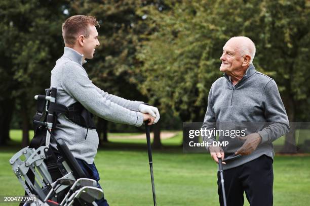 sports, talking and men on field for golf in game, match and competition on golfing course. recreation, hobby and senior man with person with disability with club for training, fitness and practice - championship day two stock pictures, royalty-free photos & images