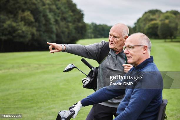 men, golf course and pointing for sports game together for collaboration or club for coaching, competition or discussion. male people, grass field and conversation for outdoor hobby, play or training - golf stock pictures, royalty-free photos & images