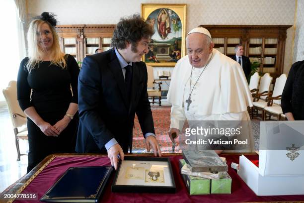 Pope Francis exchanges gifts with Argentina's President Javier Milei and his sister Karina Elizabeth Milei during an audience at the Apostolic Palace...