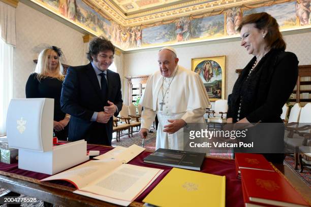 Pope Francis exchanges gifts with Argentina's President Javier Milei and his sister Karina Elizabeth Milei during an audience at the Apostolic Palace...