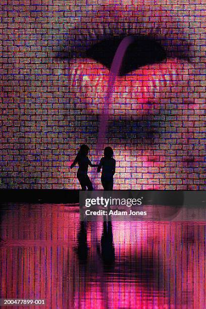 silhouette of two girls in front of crown fountain, dusk - millennium park chicago 個照片及圖片檔