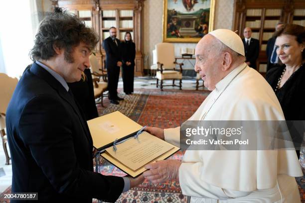 Pope Francis exchanges gifts with Argentina's President Javier Milei during an audience at the Apostolic Palace on February 12, 2024 in Vatican City,...