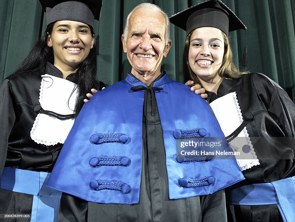 Dean with two female graduates, portrait
