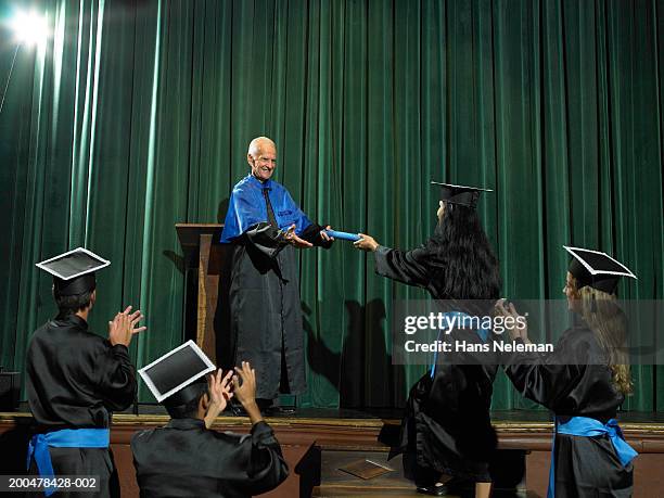 dean handing out diploma, graduates applauding - graduation podium stockfoto's en -beelden