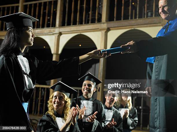 dean handing out diploma, graduates applauding - graduation podium stockfoto's en -beelden