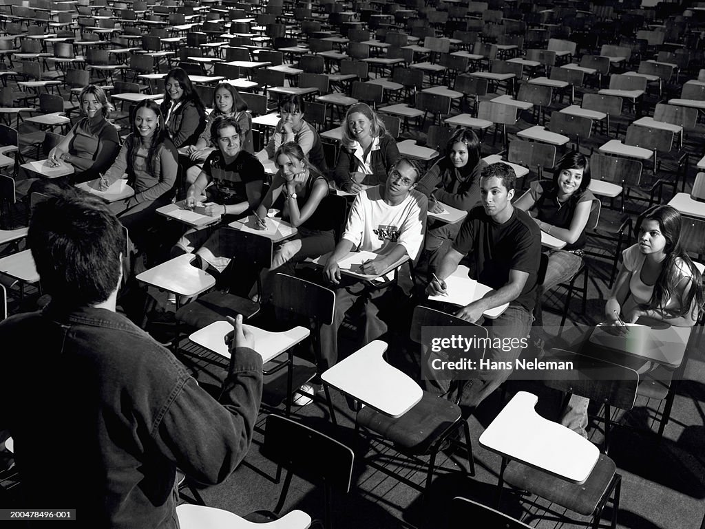 Students listening to teacher lecturing (B&W)
