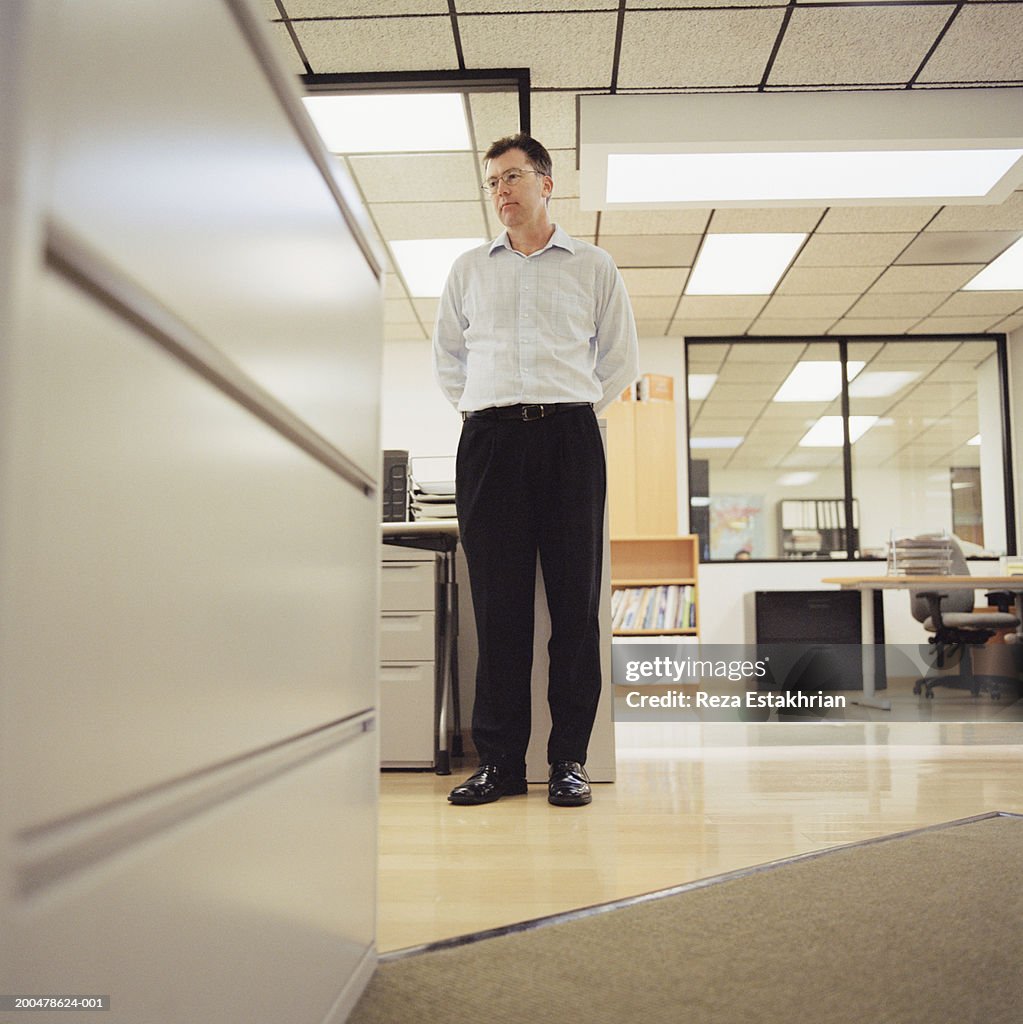 Businessman standing in office, low angle view